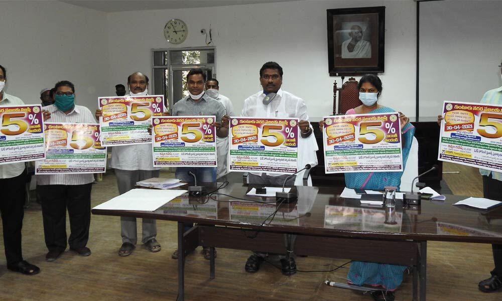 Guntur Municipal Corporation Mayor Kavati Manohar Naidu, Municipal Commissioner Challa Anuradha and other officials releasing posters on advance payment of property tax at GMC council hall in Guntur city on Thursday